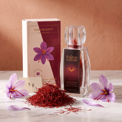 Raihan Saffron 5 g: saffron bottle and gift box with a mound of whole red Super Negin threads and crocus flowers on marble