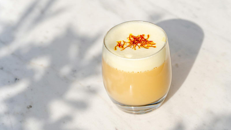 Warm dairy-free saffron almond milk with cardamom and pistachios, made with Raihan Afghan Super Negin saffron