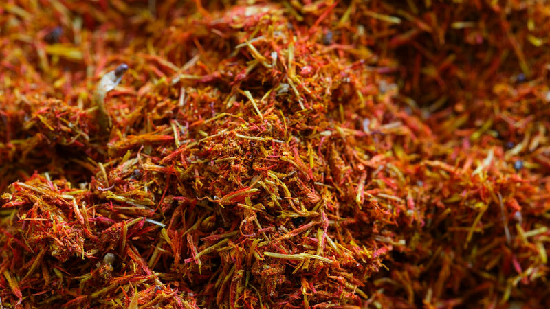 Saffron threads beside a sealed glass bottle — weighing a saffron subscription against buying once — Raihan Afghan Super Negin saffron