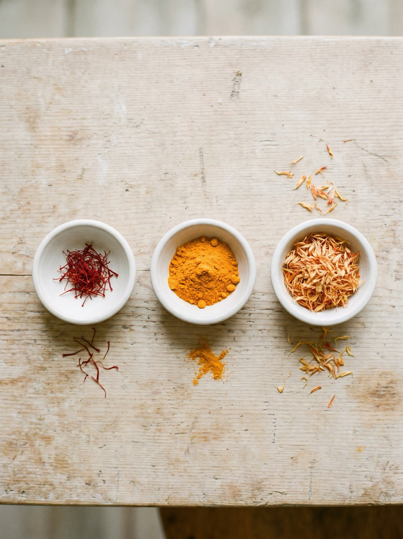 Saffron vs turmeric vs safflower — side-by-side bowls showing real saffron threads next to common substitutes