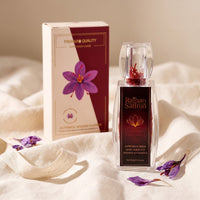 Raihan saffron bottle and gift box on ivory linen with dried crocus petals