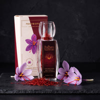 Raihan saffron gift box and crystal bottle with saffron threads and crocus flowers on black slate