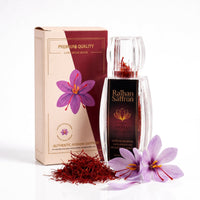 Raihan saffron bottle and gift box with whole saffron threads and fresh crocus flowers, white background