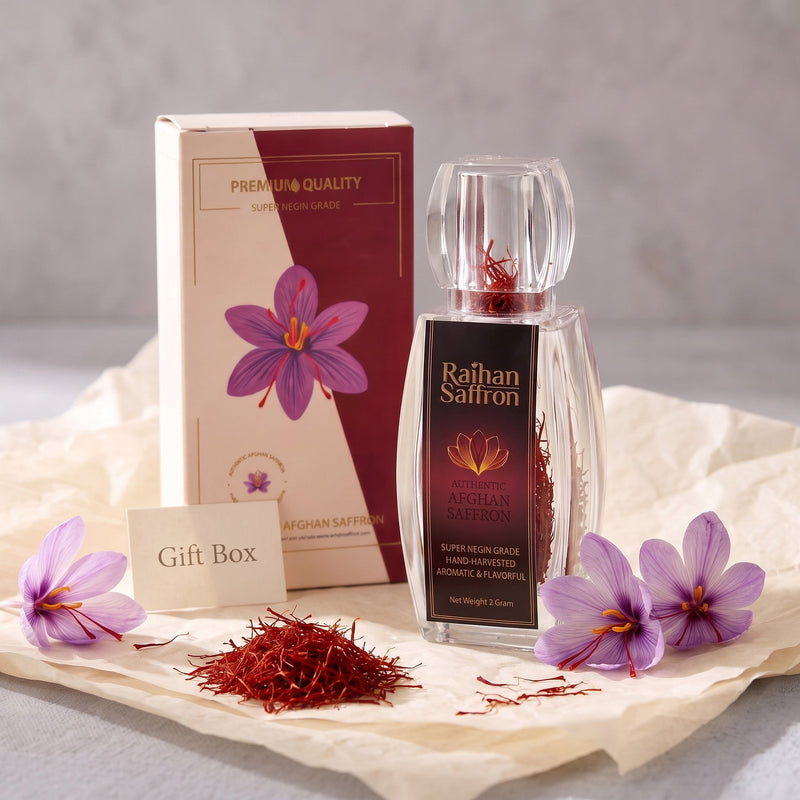 Raihan Saffron gift box and crystal bottle with whole red saffron threads and crocus flowers on tissue paper